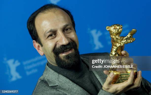 Iranian director Asghar Farhadi poses with the Golden Bear prize awarded for his film "Nader and Simin: A Separation" during the awards ceremony of...