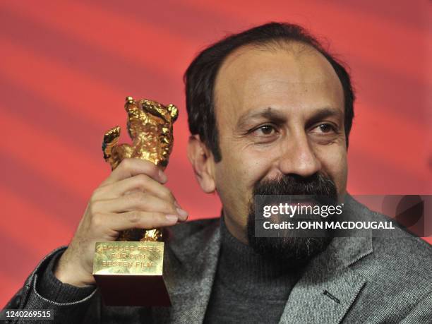 Iranian director Asghar Farhadi poses with the Golden Bear prize awarded for his film "Nader and Simin: A Separation" during a press conference after...