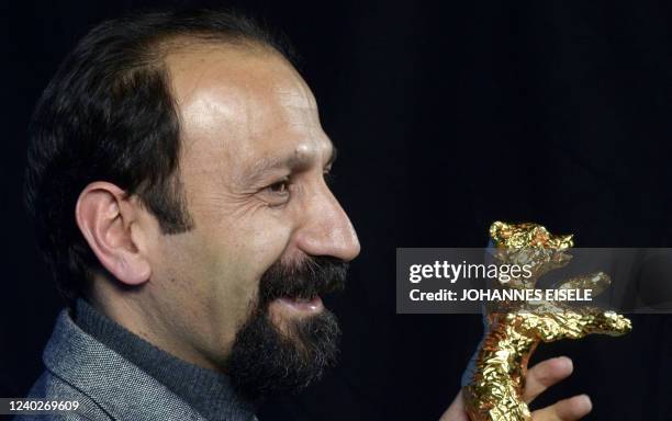 Iranian director Asghar Farhadi poses with the Golden Bear prize awarded for his film "Nader and Simin: A Separation" during the awards ceremony of...