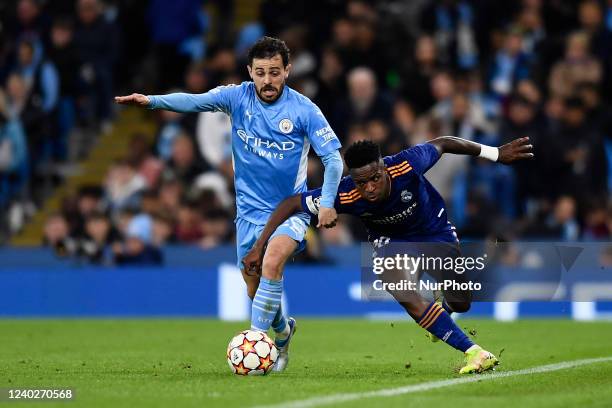 Bernardo Silva of Manchester City and Vinicius Junior of Real Madrid compete for the ball during the UEFA Champions League Semi Final Leg One match...