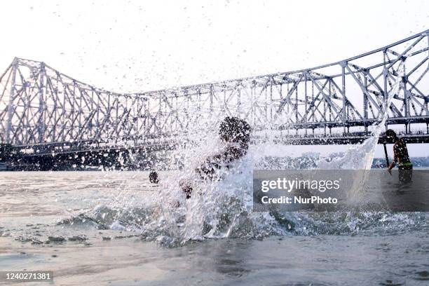 Boy jump ganga river and backside Howrah Bridge during hot weather, Kolkata Maximum Temperature In Kolkata Likely To Touch 40 Degrees on April...