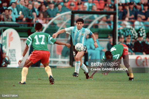 Argentina's Diego Maradona fights for the ball against Cameroon's Victor Ndip Akem and Benjamin Massing during the 1990 World cup football match...