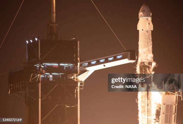 In this handout provided by the National Aeronautics and Space Administration , A SpaceX Falcon 9 rocket carrying the company's Crew Dragon...