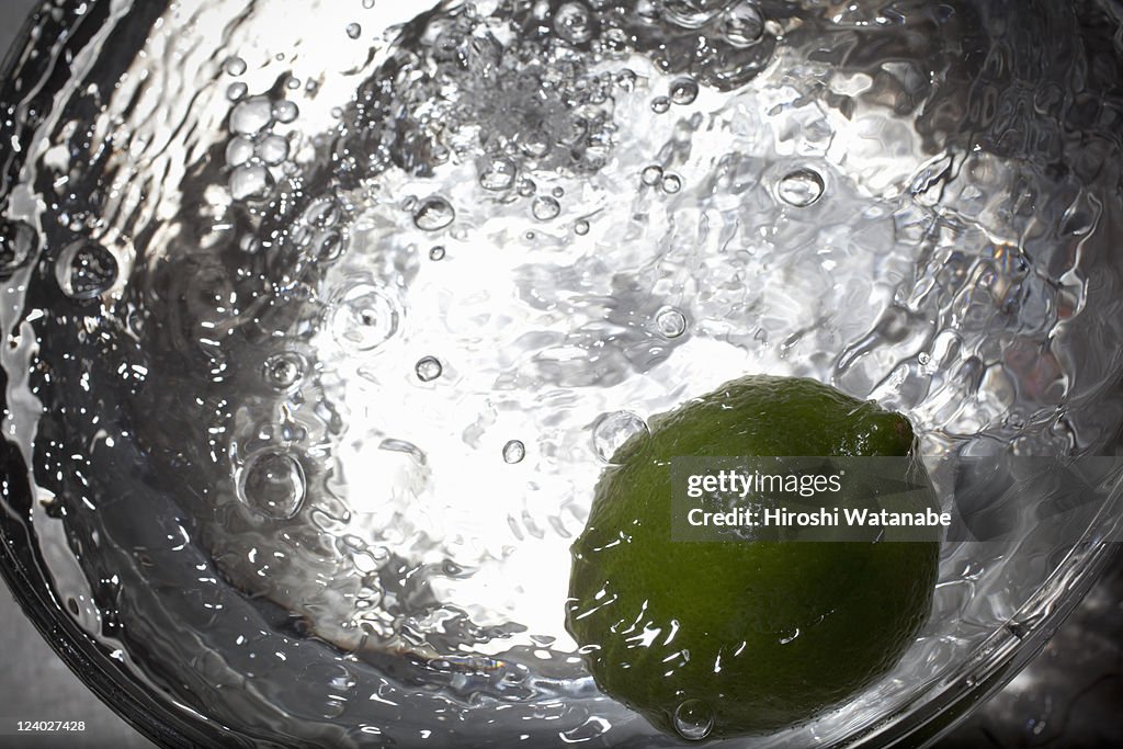 Lime in a ball with water splash