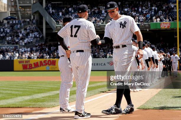 Aaron Judge of the New York Yankees is greeted by Manager Aaron Boone during player introductions prior to the game between the Boston Red Sox and...