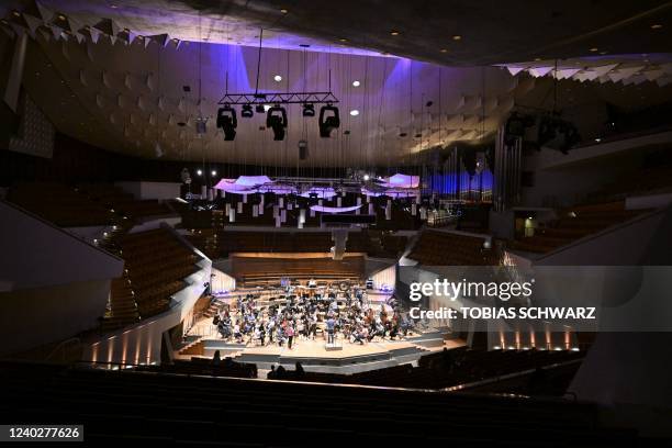 Luigi Gaggero conducts the Kyiv Symphony Orchestra during a rehearsal at the Berlin Philharmonic on April 27, 2022.