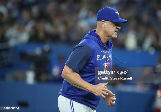 Pitching coach Pete Walker runs back in as the Toronto Blue Jays beat the Boston Red Sox 6-5 in extra innings at Rogers Centre in Toronto. April 26,...