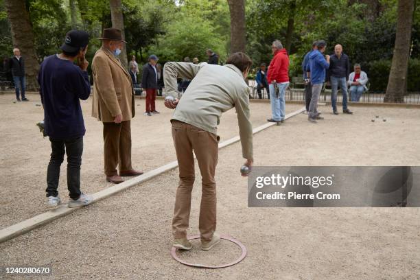 Men play Pétanque in Jardin du Luxembourg on April 26, 2022 in Paris, France.