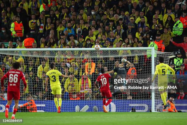 Goalkeeper Geronimo Rulli of Villarreal fails to stop the ball from entering the net after it took a deflection from Pervis Estupinan following a...