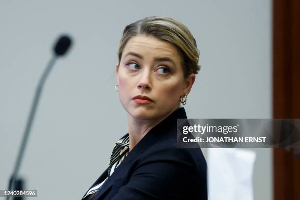 Actor Amber Heard attends her ex-husband Johnny Depp's defamation trial against her, at the Fairfax County Circuit Courthouse in Fairfax, Virginia,...