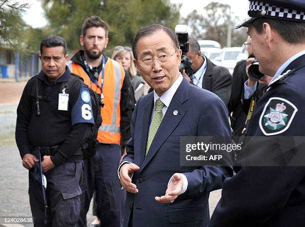 Secretary-General Ban Ki-Moon speaks to an Australian federal police officer during a visit to the International Deployment Group complex in Canberra...