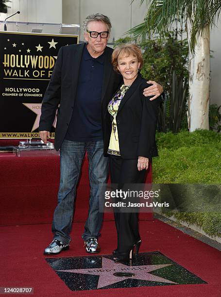 Actor Gary Busey and Maria Elena Holly attend Buddy Holly's induction into The Hollywood Walk of Fame on September 7, 2011 in Hollywood, California.