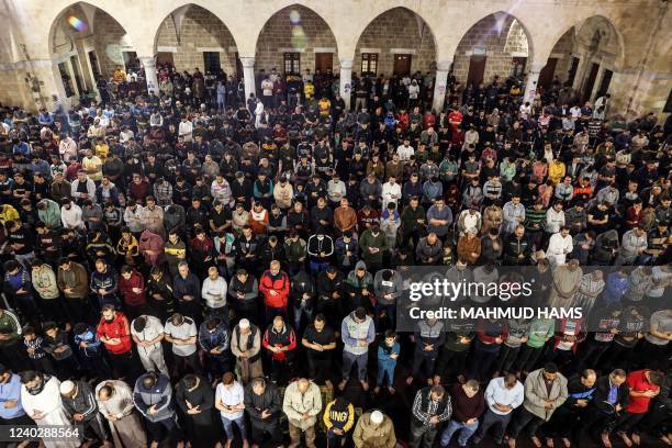 Palestinian devotees pray during Laylat al-Qadr during the Islamic holy month of Ramadan at Sayed al-Hashim Mosque in Gaza City, early on April 28,...