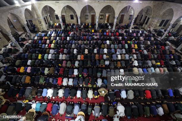 Palestinian devotees pray during Laylat al-Qadr during the Islamic holy month of Ramadan at Sayed al-Hashim Mosque in Gaza City, early on April 28,...