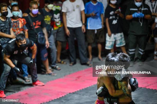 This photo taken on April 16, 2022 shows combatants competing in Muay Thai at an event by Fight Club Thailand, an underground organisation that hosts...
