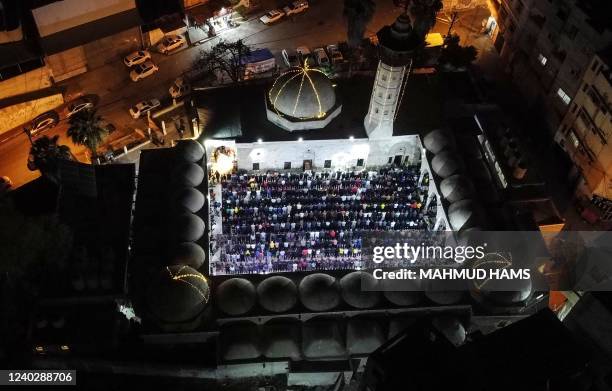 Palestinian devotees pray during Laylat al-Qadr during the Islamic holy month of Ramadan at Sayed al-Hashim Mosque in Gaza City, early on April 28,...