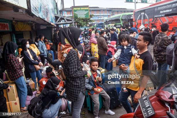 Hundreds of intercity bus passengers wait to board their respective buses at the bus terminal in Bekasi on April 28 as they head to their hometowns...