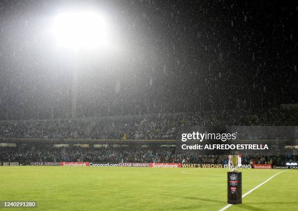 The trophy is seen under the rain before the first leg CONCACAF Champions League final match between Pumas and the Seattle Sounders at the Olimipico...