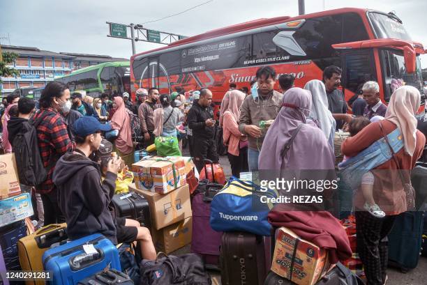 Hundreds of intercity bus passengers wait to board their respective buses at the bus terminal in Bekasi on April 28 as they head to their hometowns...