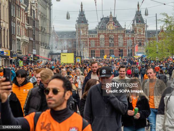 People wearing orange clothes are seen arriving at the city from the central train station. After two years of restrictions, this year's King's Day...