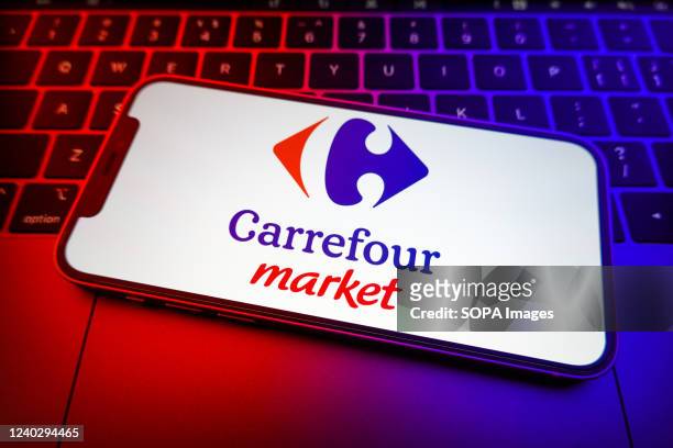 In this photo illustration, a Carrefour market logo seen displayed on a smartphone screen.