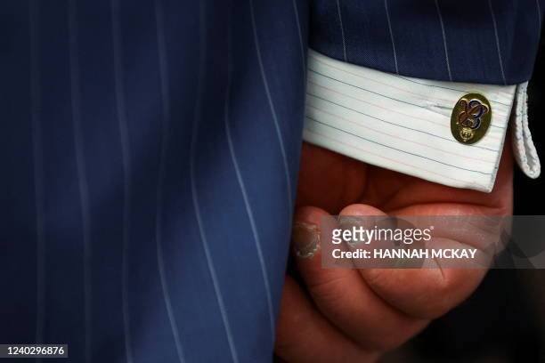 Cufflink of Britain's Prince Charles, Prince of Wales is pictured during his visit to the BBC World Service, in London, on April 28 for its 90th...