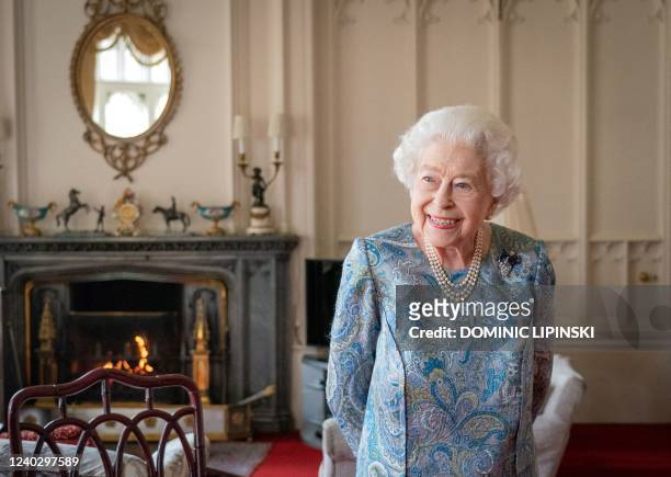 Britain's Queen Elizabeth II reacts during an audience with Switzerland's President Ignazio Cassis at Windsor Castle, west of London on April 28,...