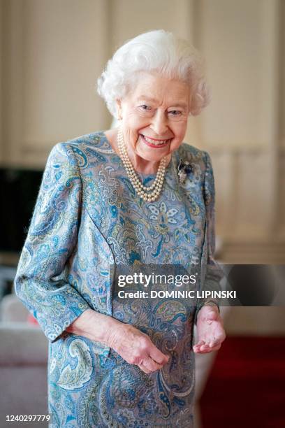 Britain's Queen Elizabeth II reacts during an audience with Switzerland's President Ignazio Cassis at Windsor Castle, west of London on April 28,...