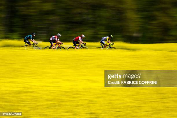 Spain's Diego Lopez Fuentes , Latvia's Toms Skujins , Switzerland's Nils Brun and Belgium's Baptiste Planckaert ride past a rapeseed field during...