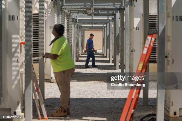 Electrical technicians outside bitcoin mining containers at a Cleanspark facility in College Park, Georgia, U.S., on Friday, April 22, 2022. Georgia...
