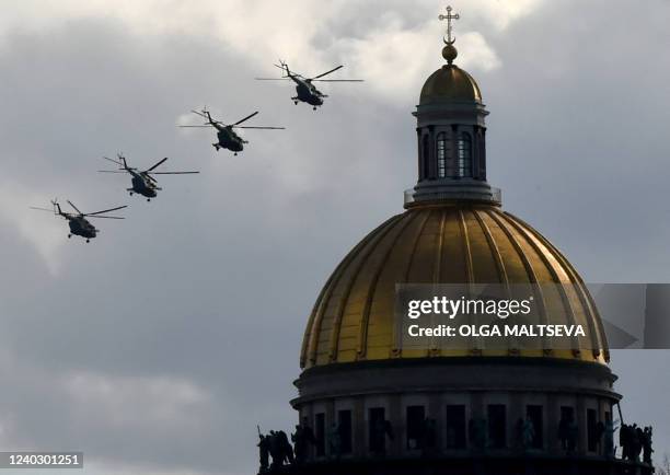 Russian military helicopters fly over Dvortsovaya Square during a rehearsal for the Victory Day military parade in Saint Petersburg on April 28,...