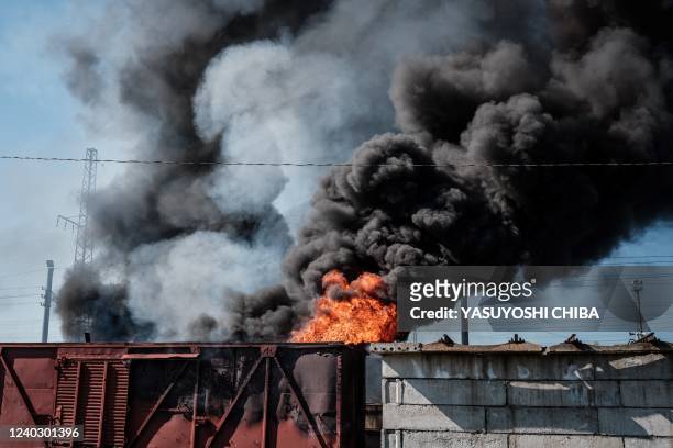 Car and piled sleepers are burning after a shelling near the Lyman station in Lyman, eastern Ukraine, on April 28 amid Russian invasion of Ukraine.