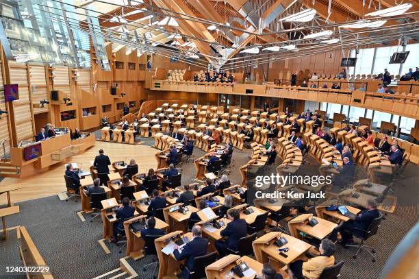 The chamber of the Scottish Parliament during First Minister's Questions, with many more MSPs in their places and visitors in the public gallery...