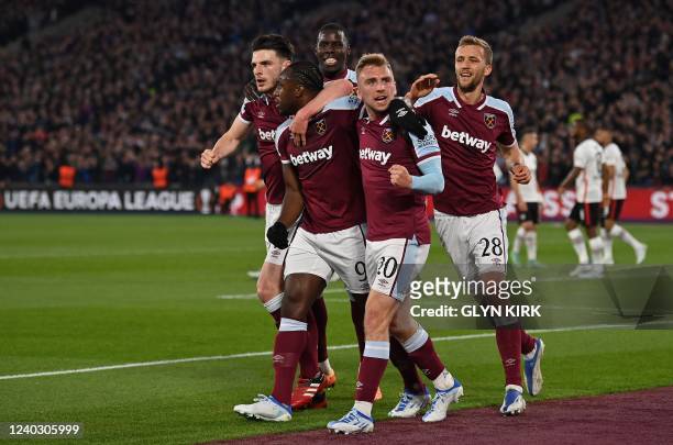 West Ham United's English midfielder Michail Antonio celebrates after scoring the equalising goal with West Ham United's English midfielder Declan...