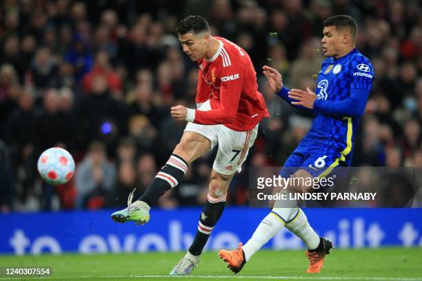 Manchester United's Portuguese striker Cristiano Ronaldo shoots past Chelsea's Brazilian defender Thiago Silva to score their first goal during the...