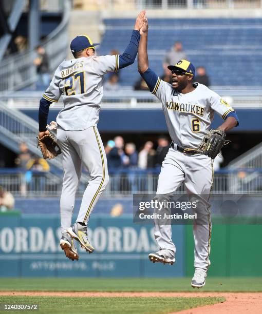Willy Adames of the Milwaukee Brewers high fives with Lorenzo Cain after the final out in a 3-2 win over the Pittsburgh Pirates during the game at...