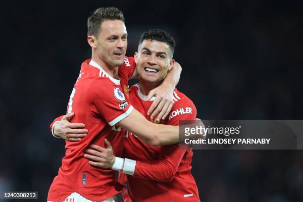 Manchester United's Portuguese striker Cristiano Ronaldo celebrates with Manchester United's Serbian midfielder Nemanja Matic after scoring their...