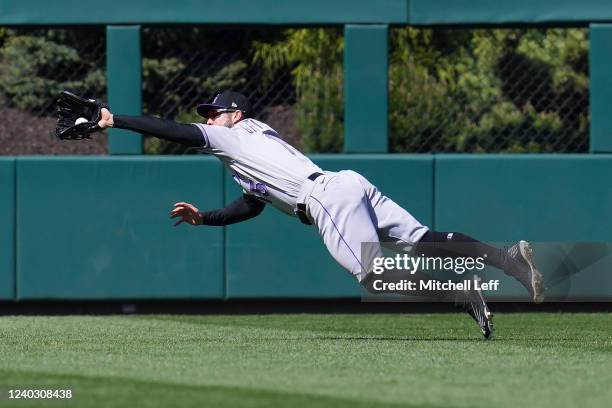 Randal Grichuk of the Colorado Rockies makes a diving catch on a ball hit by Alec Bohm of the Philadelphia Phillies in the bottom of the seventh...