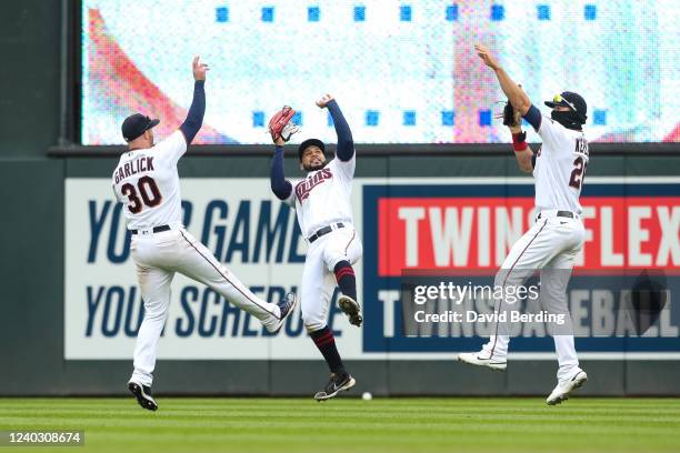 Kyle Garlick, Gilberto Celestino, and Max Kepler of the Minnesota Twins celebrate a 7-1 victory against the Detroit Tigers at Target Field on April...