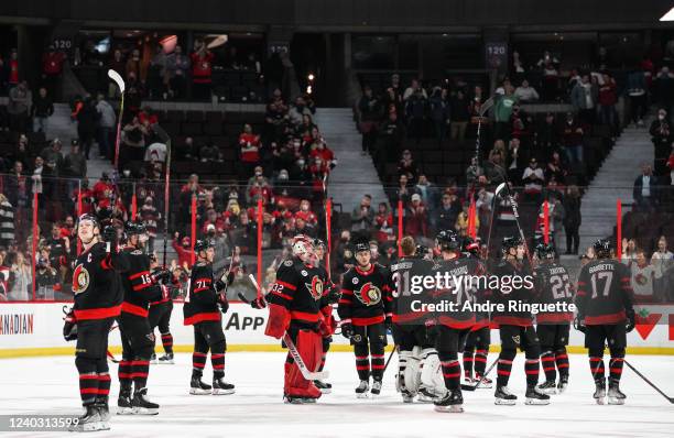 Brady Tkachuk and members of the Ottawa Senators raise their sticks to salute the fans after the last home game of the season against the Florida...