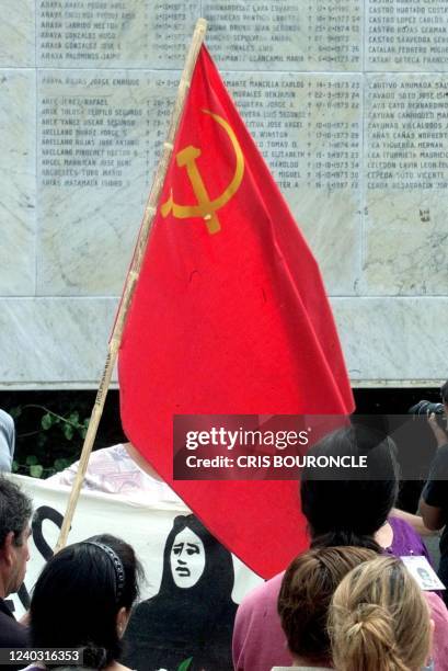 Flag of the communist party waved during an organized act for adherents of the Group of Families of Executed Politicians in the cemeteary general of...