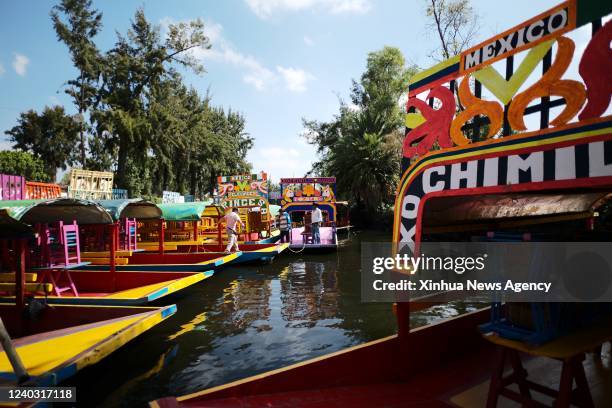 Boatman walks on the "trajineras" on the lake of Xochimilco, in Mexico City, capital of Mexico, April 27, 2022. Xochimilco was declared in 1987 as...