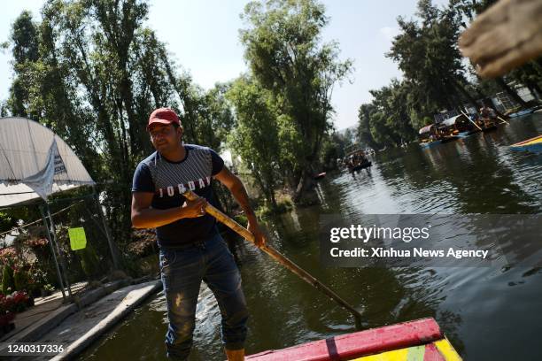 Boatman rows a "trajinera" over the lake of Xochimilco, in Mexico City, capital of Mexico, April 27, 2022. Xochimilco was declared in 1987 as World...