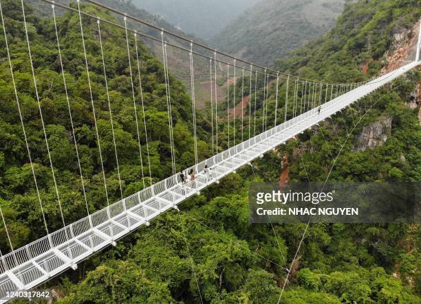 This aerial photo shows the newly constructed Bach Long glass bridge in Moc Chau district in Vietnam's Son La province on April 29, 2022. - Vietnam...