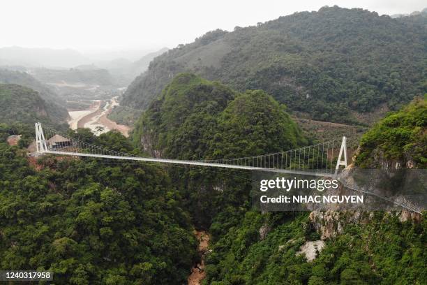 This aerial photo shows the newly constructed Bach Long glass bridge in Moc Chau district in Vietnam's Son La province on April 29, 2022. - Vietnam...