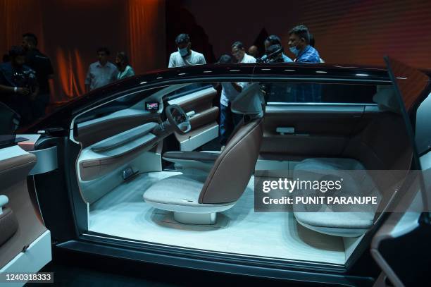Members of the media take pictures of the new Tata Motors concept car 'Avinya', which is based on the Pure EV architecture , during its unveiling...