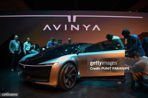 Members of the media take pictures of the new Tata Motors concept car 'Avinya', which is based on the Pure EV architecture , during its unveiling...
