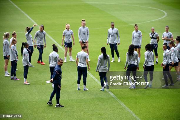 Paris Saint-Germain's French head coach Didier Olle-Nicolle and Paris Saint-Germain's players attend a training session on the eve of the UEFA...