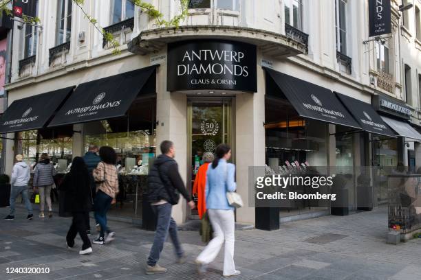Pedestrians pass window shoppers browsing the Orsini Diamonds store in the Diamond Quarter of Antwerp, Belgium, on Thursday, April 28, 2022. The...