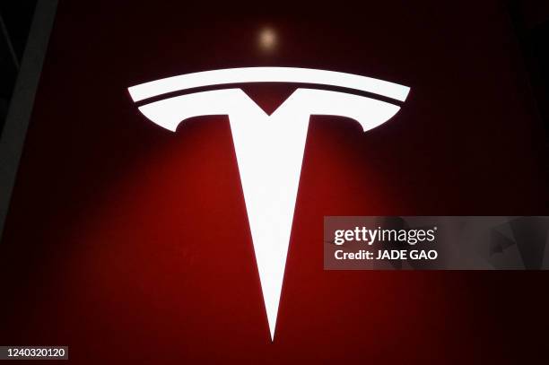 Tesla logo is seen at a Tesla showroom at a shopping mall in Beijing on April 29, 2022.